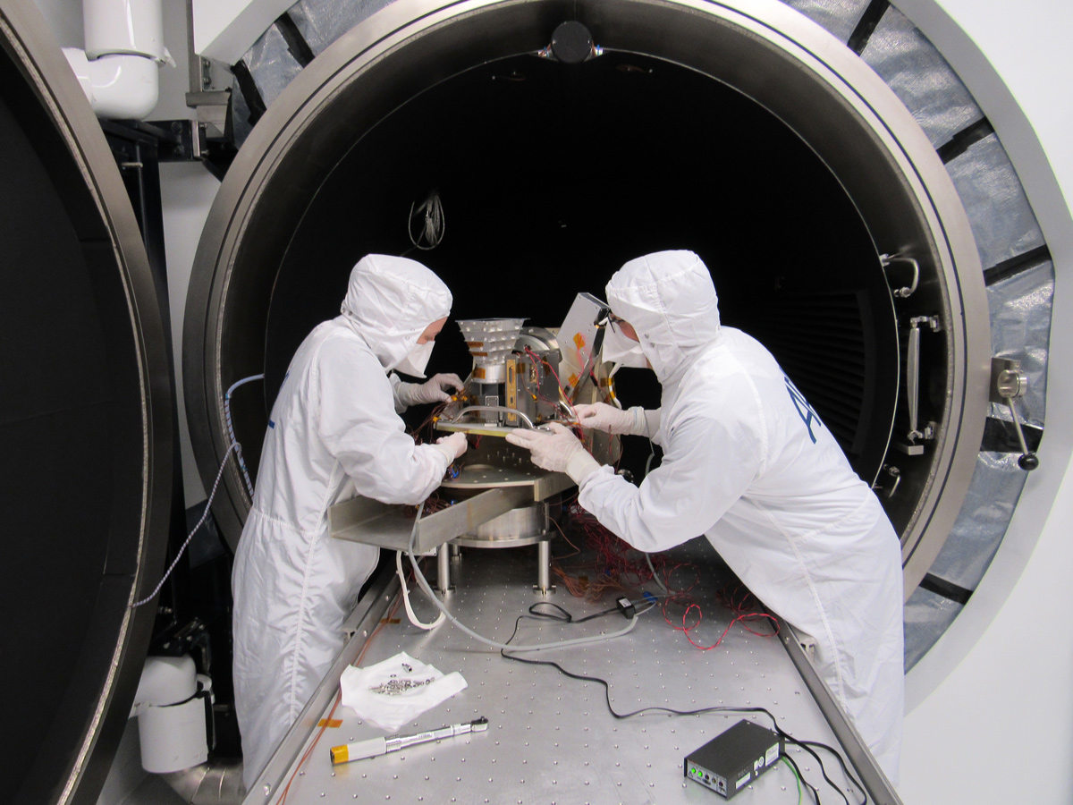 Mechanical engineers set up Europa Clipper's wide-angle camera outside of a thermal-vacuum chamber. The wide-angle camera is part of the spacecraft's Europa Imaging System, or EIS (pronounced "ICE"), which also includes a narrow-angle camera. The cameras, each with an eight-megapixel sensor, will produce high-resolution color and stereoscopic images of Europa. They will study geologic activity, measure surface elevations, and provide context for other instruments.