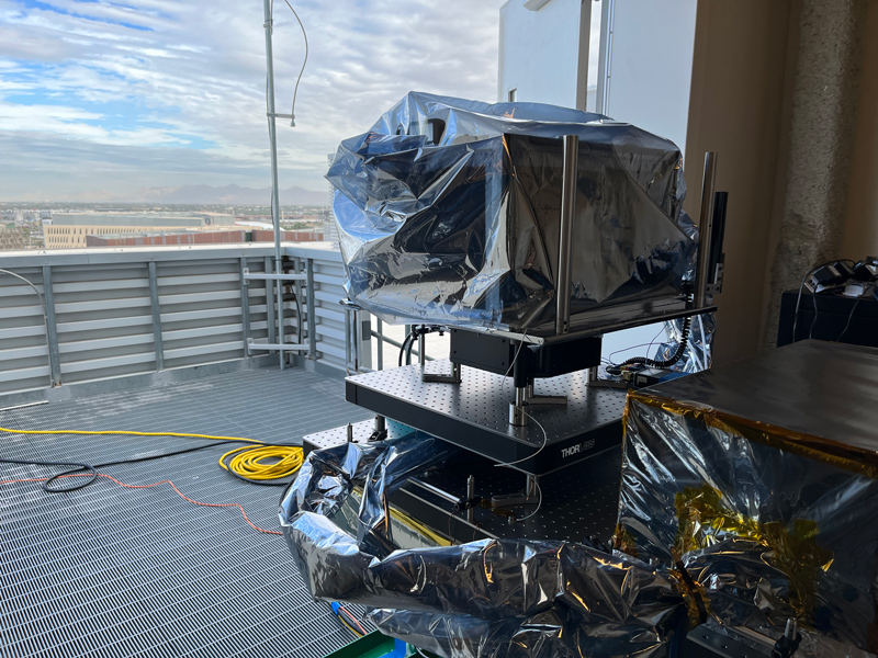 Europa Clipper’s thermal imager (called E-THEMIS) is shown here in its protective enclosure, viewing the Tempe Campus of Arizona State University during testing on a rooftop lab.