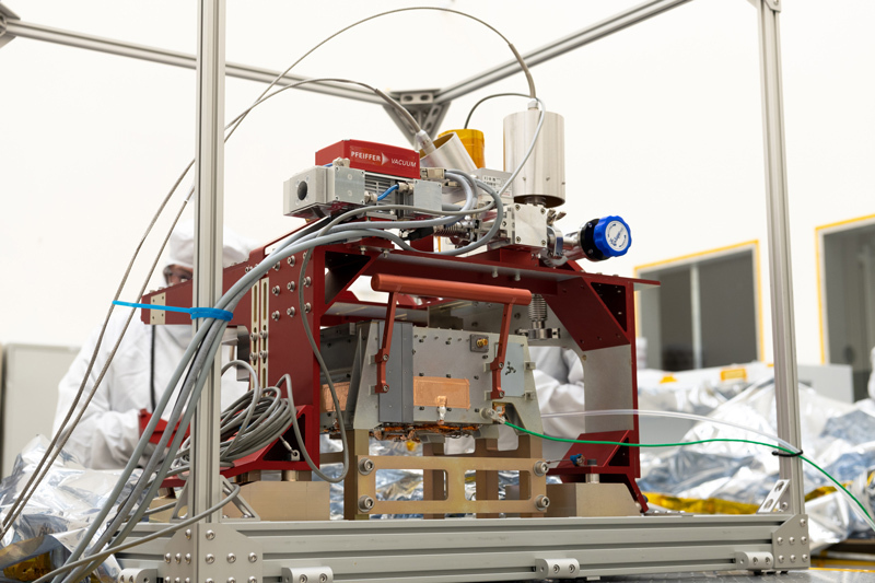 Engineers inspecting Europa Clipper's ultraviolet spectrograph in a cleanroom at NASA's Jet Propulsion Laboratory in Southern California, following the delivery of the instrument from Southwest Research Institute (SwRI). SwRI designed and built the instrument, which collects ultraviolet light with a telescope and creates images to help determine the composition of Europa’s atmospheric gases and surface materials. 