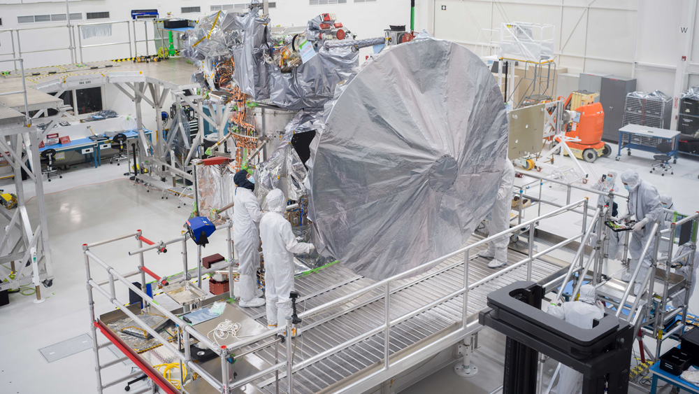 Engineers and technicians install a 10-foot (3-meter) high-gain antenna on NASA’s Europa Clipper spacecraft on Aug. 14, 2023. The orbiter is being assembled in the clean room of the High Bay 1 clean room of the Spacecraft Assembly Facility at the agency’s Jet Propulsion Laboratory, in preparation for launch to Jupiter’s moon Europa in October 2024. The precision-engineered dish was attached to the spacecraft in carefully choreographed stages over the course of several hours. Europa Clipper will need the huge antenna to transmit data hundreds of millions of miles back to Earth. Scientists believe the icy moon Europa harbors a vast internal ocean that may have conditions suitable for supporting life. The spacecraft will fly by the moon about 50 times while its science instruments gather data on the moon’s atmosphere, surface, and interior – information that will help scientists learn more about the ocean, the ice crust, and potential plumes that may be venting subsurface water into space. 