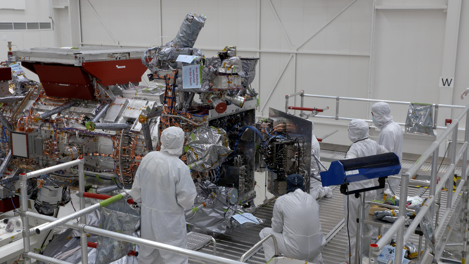 Engineers and technicians are seen closing the vault of NASA's Europa Clipper in the main clean room of the Spacecraft Assembly Facility at the agency's Jet Propulsion Laboratory in Southern California on Oct. 7, 2023. The vault will protect the sophisticated electronics of the spacecraft as it orbits Jupiter and endures one of the most punishing radiation environments in our solar system.