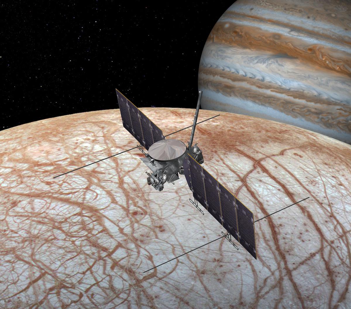 spacecraft over surface of Europa with Jupiter in background