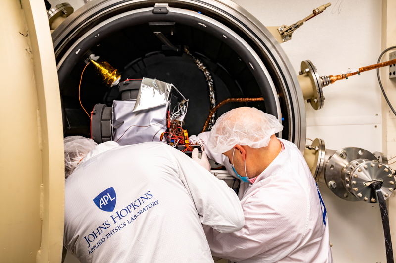 A plasma instrument sensor assembly is loaded into a thermal vacuum chamber.