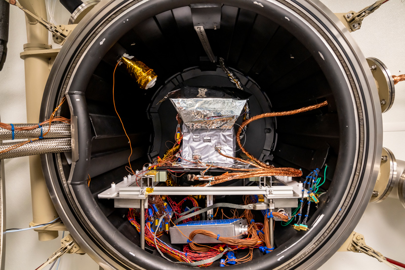 A plasma instrument sensor assembly loaded into a thermal vacuum chamber.