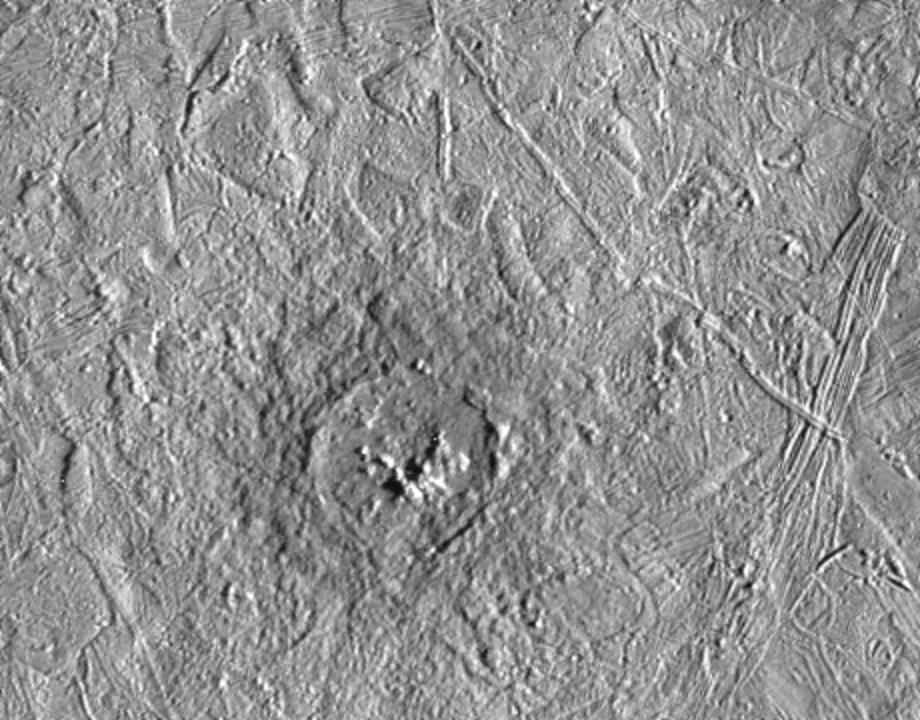 black and white view of circular crater on icy surface