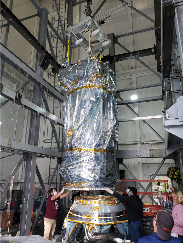 Europa Clipper's developmental test model is lowered by crane in a static test tower.