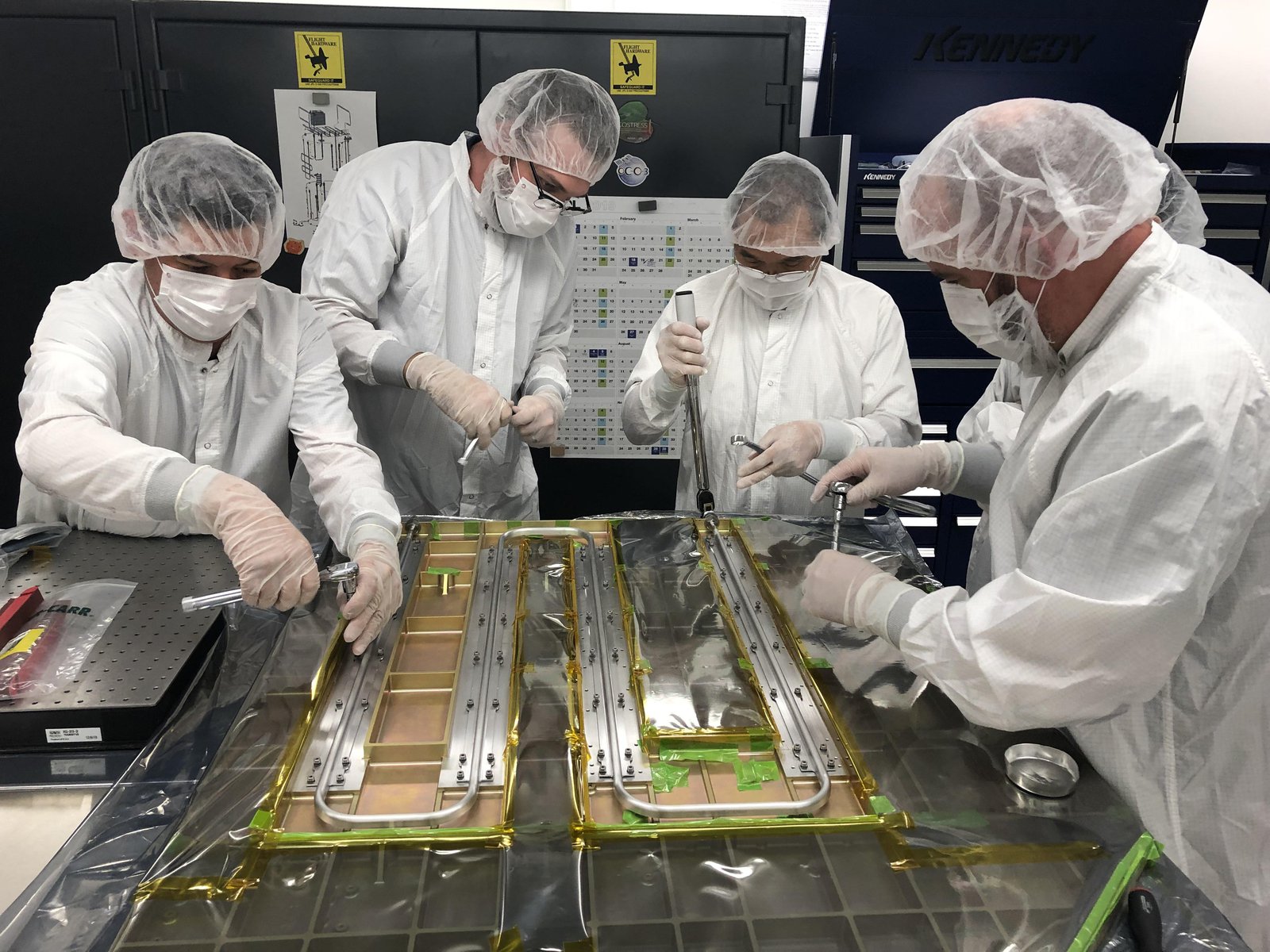 Members of the Europa Clipper team work on the spacecraft’s heat redistribution system at Jet Propulsion Laboratory in 2019.