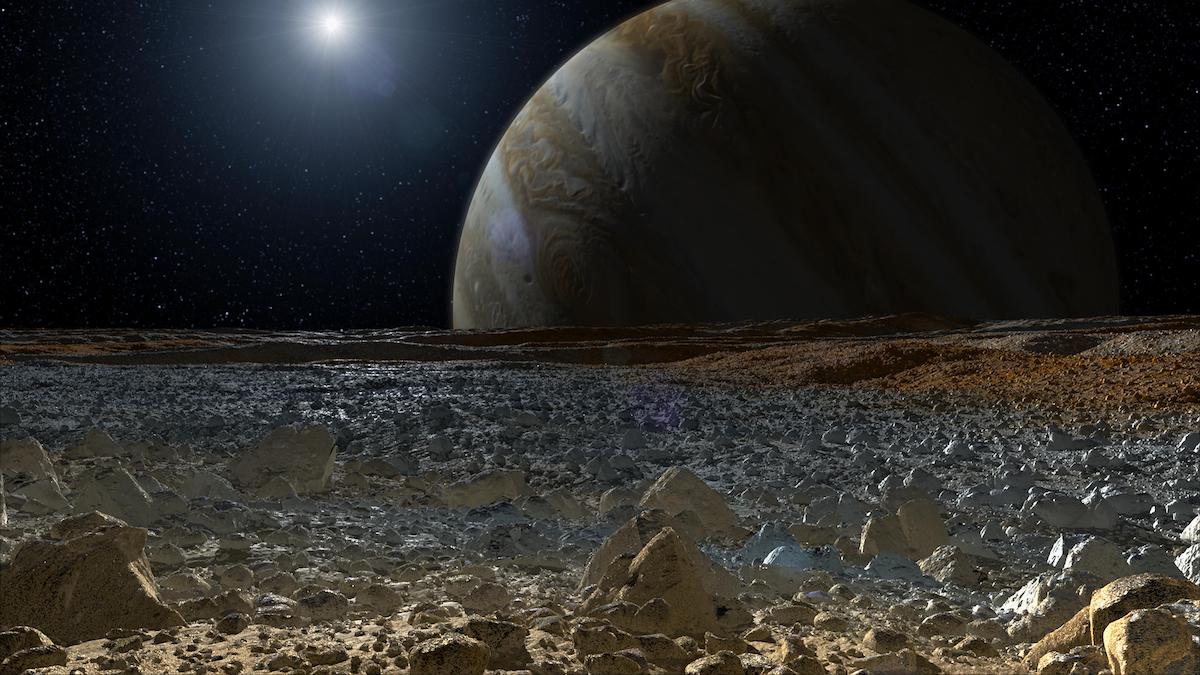 field of icy boulders with jupiter rising over the horizon