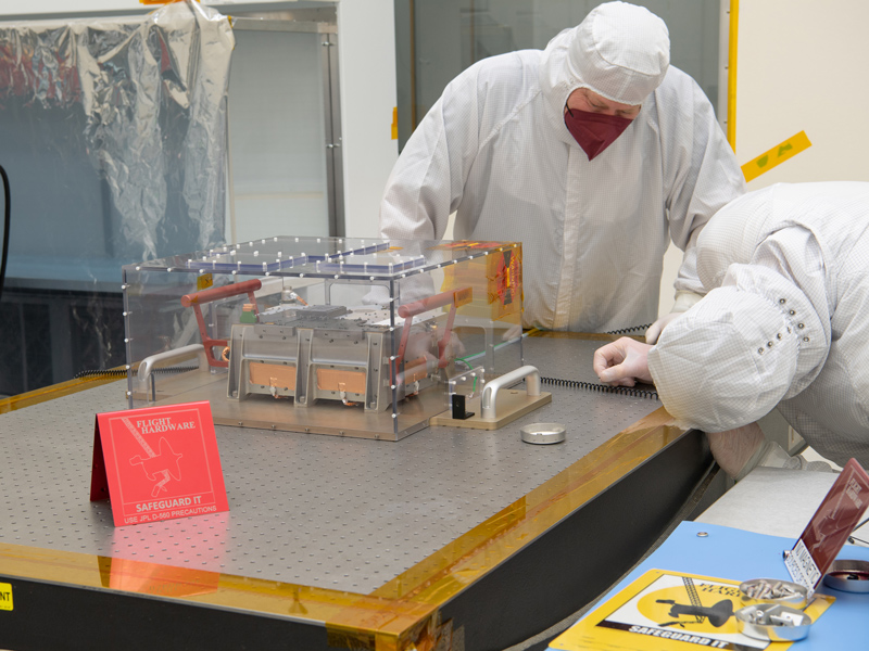 Engineers inspect Europa Clipper's ultraviolet spectrograph in a cleanroom at NASA's Jet Propulsion Laboratory in Southern California