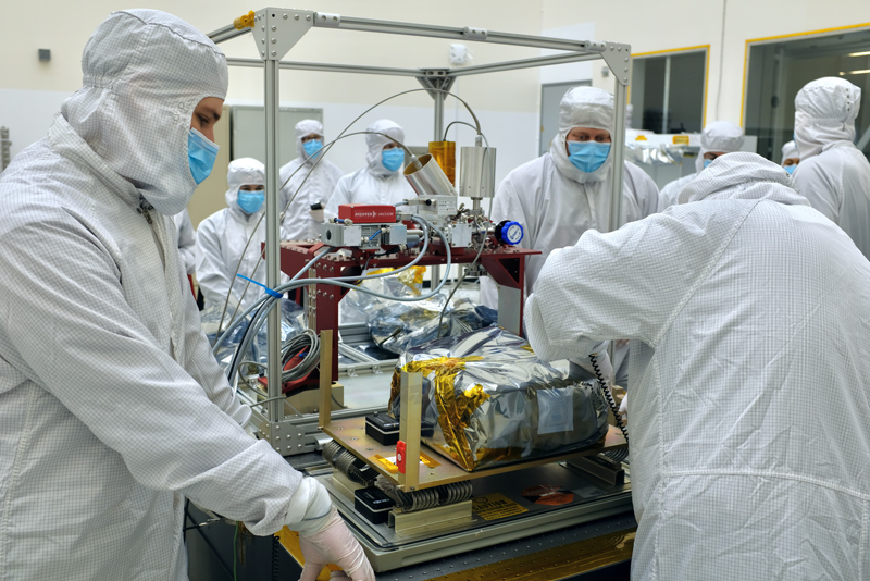 Engineers inspect Europa Clipper's ultraviolet spectrograph in a cleanroom at NASA's Jet Propulsion Laboratory in Southern California.