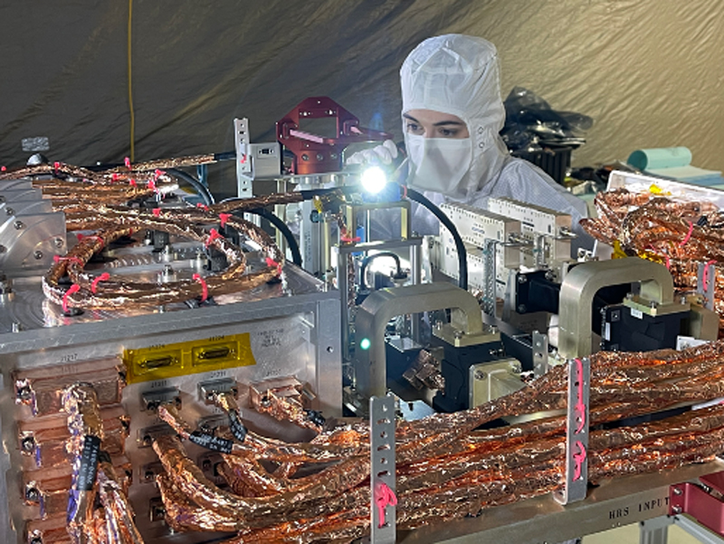 An engineer inspects the radio frequency (RF) panel of NASA’s Europa Clipper.
