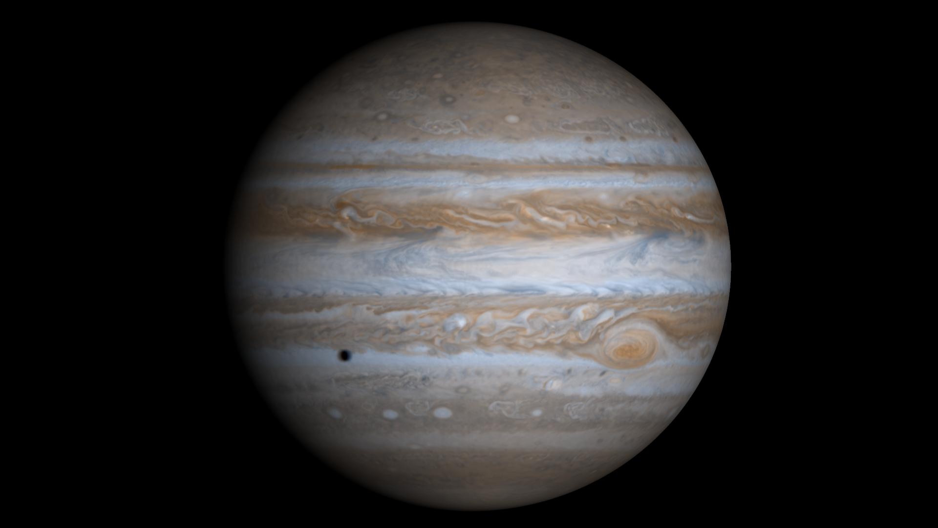 full disc of jupiter with small shadow on cloud tops 