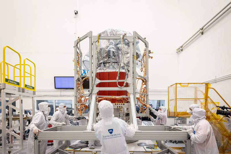 people working on the spacecraft in the clean room