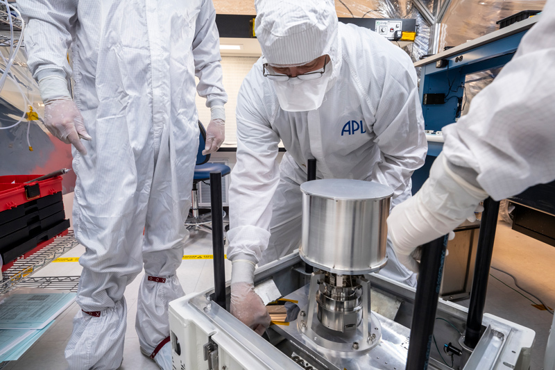 Members of Europa Clipper’s imaging spectrometer instrument, called MISE, team at the Johns Hopkins Applied Physics Laboratory carefully package the instrument’s scanning mirror and data processing unit into a specialized shipping container.