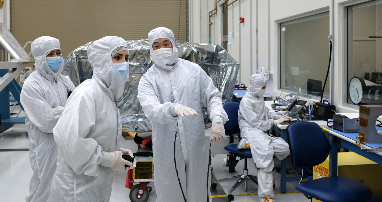 In a clean room at NASA’s Jet Propulsion Laboratory, Mana Salami, guidance and control (G&amp;C) systems engineer (front left) and Herrick Chang, cognizant engineer (front right), discuss testing for Europa Clipper’s star tracker. At far left is G&amp;C hardware engineer Gabrielle Massone. At far right sits quality assurance engineer Shaunessy Grant. Chang, Massone, Grant, and James Alexander (not pictured) escorted the hardware from the Sodern company in France to JPL. 
